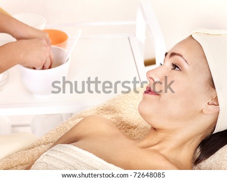 Young woman with gold facial mask.