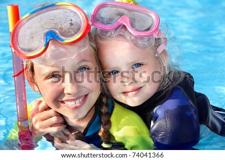 Children in swimming pool learning snorkeling. Sport.
