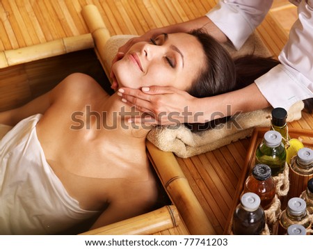Young woman getting massage in bamboo spa Young woman getting massage in bamboo spa