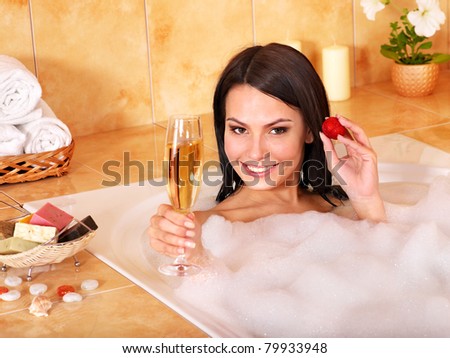 Woman swimming of bath tub.