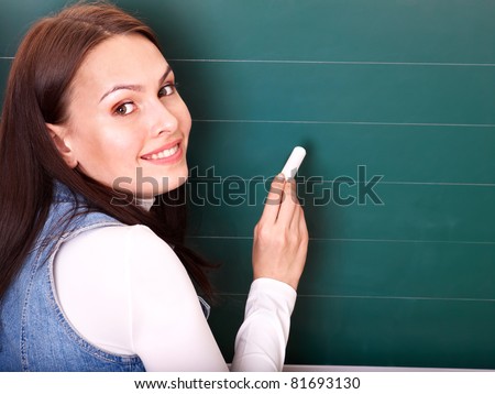 Happy student writing on blackboard.