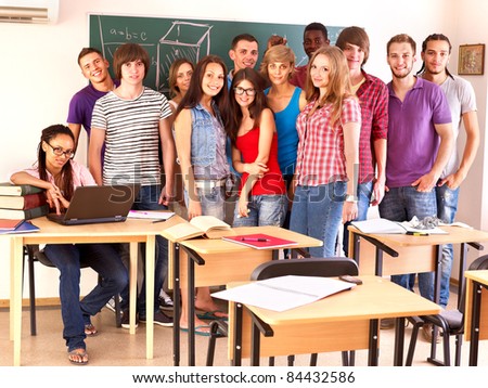 Group student in classroom near blackboard.