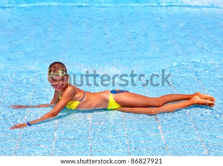Child in swimming pool. Water sport.