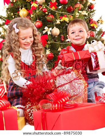 Children with gift box near Christmas tree. Isolated.