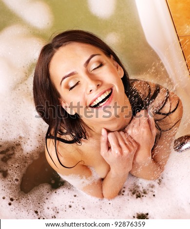 Young woman take bubble  bath.
