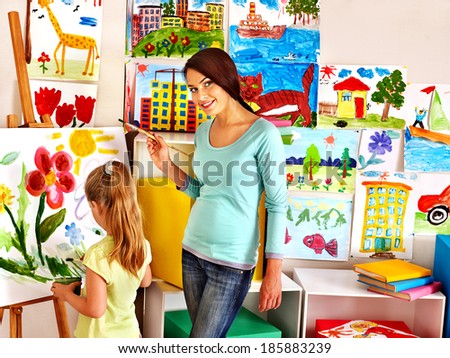 Happy children  with teacher painting.