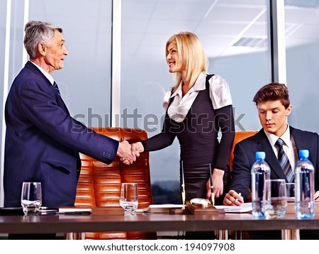 Happy group business people in office.Handshake.