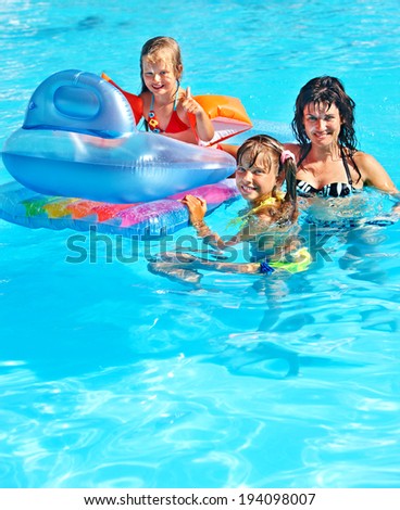Family with children in swimming pool. Summer outdoor.