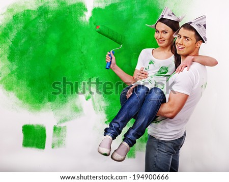 Happy family paint wall at home.