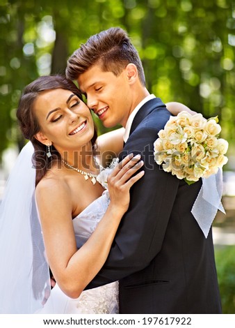 Bride and groom with flower summer  outdoor.