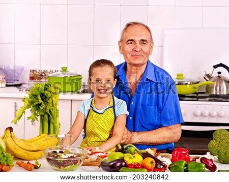 Big family cooking at kitchen. Grandfather and children.