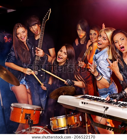Musical group male and female  performance in night club.