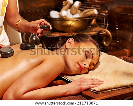 Young woman having Ayurveda stone massage.