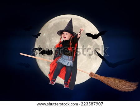 Kid witch flying on broomstick. Halloween moon.