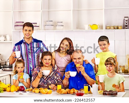 Big happy family have breakfast at kitchen.