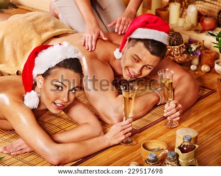 Man and woman relaxing in Christmas spa.