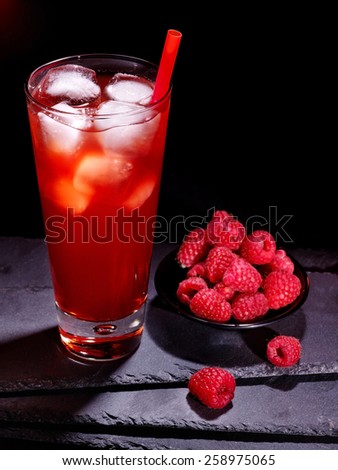 Red raspberry drink  with ice cube on black background. Cocktail card 5.