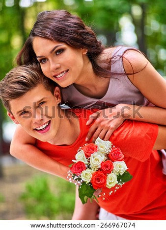 Couple with flower at park. Outdoor first date.