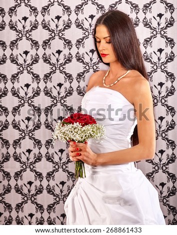 Sad bride in wedding dress on wallpapers bachground.