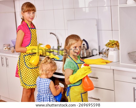 Children little girl cooking at kitchen.