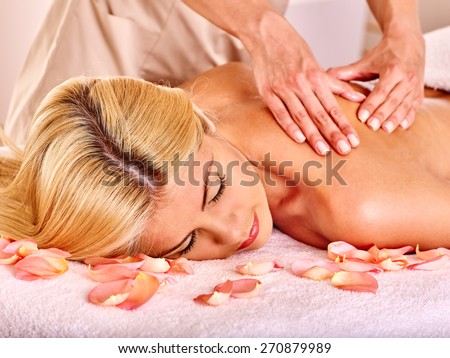 Blond beautiful woman getting massage. Hands on shoulder