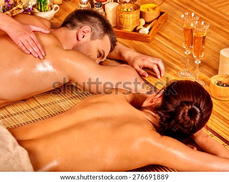 Man and woman relaxing in bamboo spa. Loving couple.