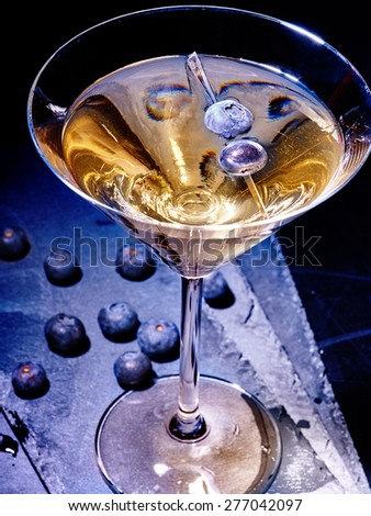 Blueberry gold drink on black background. Cocktail card