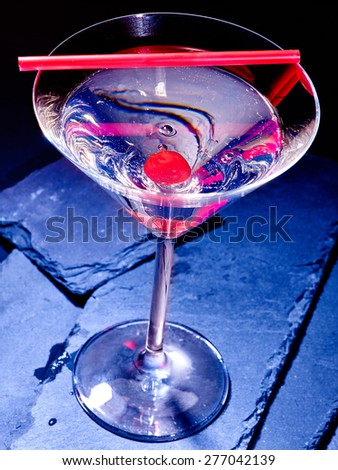 Transparent cherry cocktail on black background. Top view. Cocktail card 48