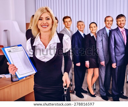Happy group business people together  in office. Woman in foreground.