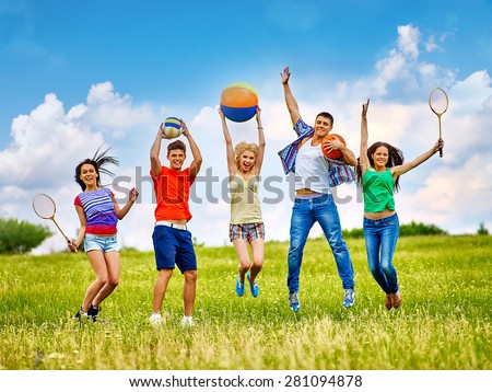 Happy group people with children playing beach ball summer outdoor.