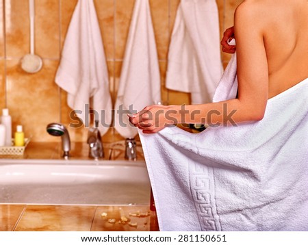 Woman relaxing at water in bubble bath.  In frame of visible part female