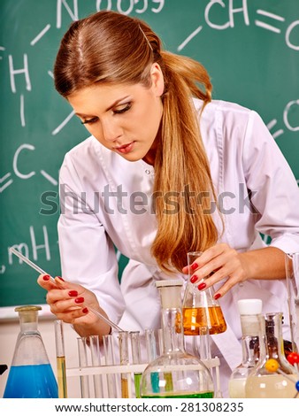 Chemistry teacher with test-tube working at chemistry classroom.