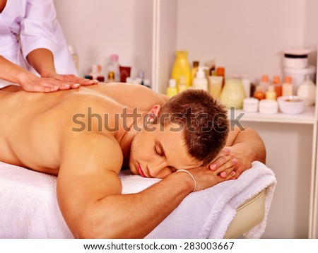 Man getting relaxing massage in spa.