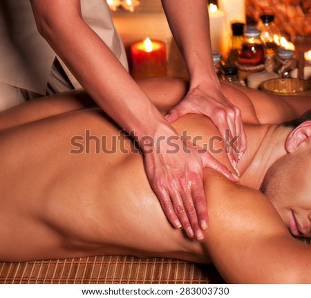 Man getting massage in spa. Female therapist.