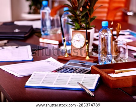 Business interior on table with clock and leather chair in office. Top view.