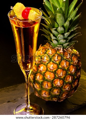 Champagne  cocktail with cherry and whole pineapple with leaves . Cocktail card 67.