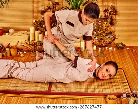 Therapist giving stretching massage to woman.