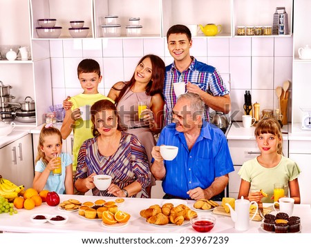 Big happy family have breakfast at kitchen. Seven people