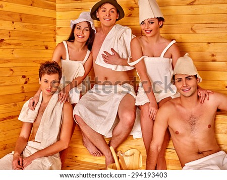Group people men and women in hat  relaxing in sauna.
