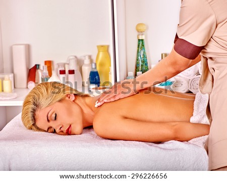 Blond woman sleep and getting massage in health resort.