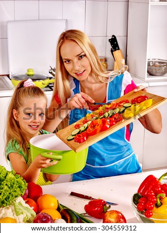Mother and daughter cooking food at kitchen. Family cooking at home