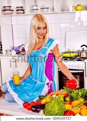 Happy woman cooking breakfast at kitchen.