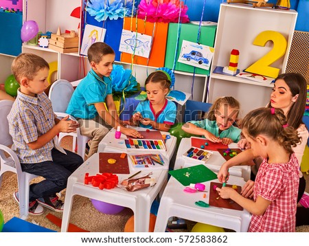 Child dough play in school. Plasticine for children. mold from plasticine in kindergarten .Kids knead modeling clay with hands in preschool.
