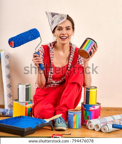 Repair home woman holding paint roller for wallpaper. Girl in newspaper cap renovation apartment . Discounts for building materials students. Woman likes repair apartment.
