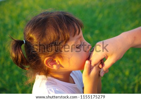 the little girl kisses the old human\'s hand. Muslims kiss the hand of old people on religious holidays. Victim and Ramadan feast
