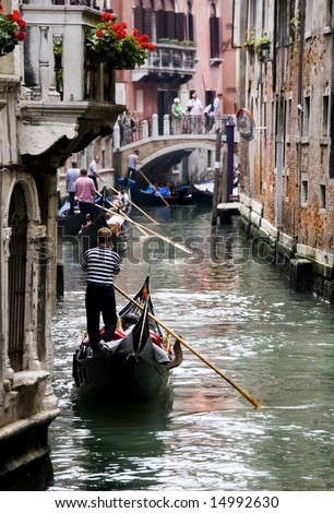 crowded venice canal with gondola using cell phone