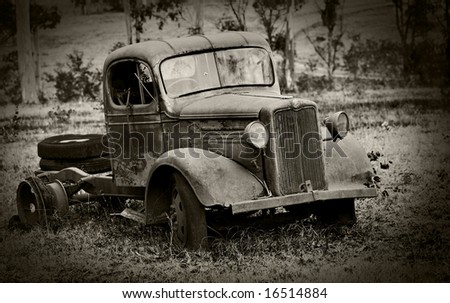 pre world war II farm truck rusted and in disrepair sepia toned