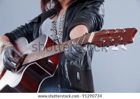 girl with a guitar plays rock music