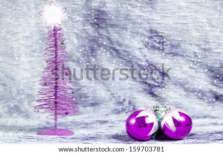 Christmas tree with bright star with balls on silver background, with space to write text