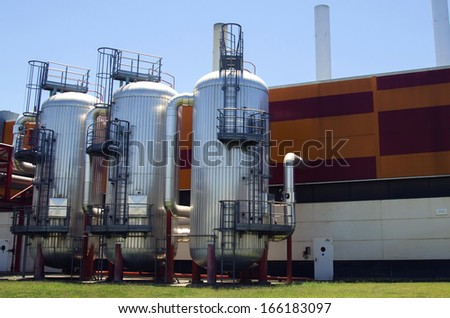 Industrial containers in factory with blue sky